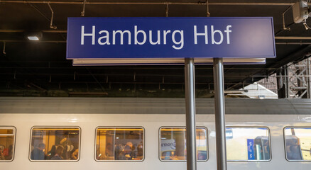 The central station of Hamburg, Germany. Focus on a plate with the text "Hamburg Hbf" ("Hbf" abbreviation for "Hauptbahnhof" central station).