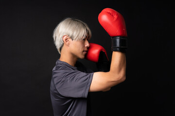 Young asian sport man over isolated black background