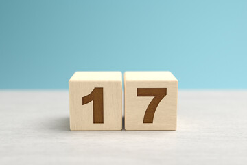 Wooden toy blocks forming the number 17.