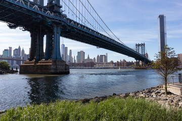 Fototapeta na wymiar Dumbo Brooklyn Riverfront with the Manhattan Bridge over the East River in New York City