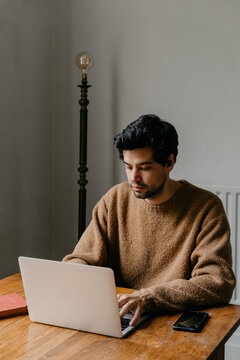 Man working on a laptop at home