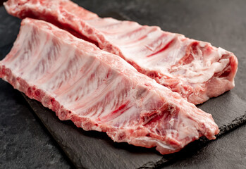 
raw pork ribs on a stone background