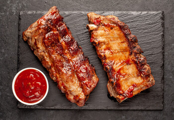 grilled pork ribs with spices on a stone background