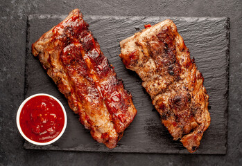grilled pork ribs with spices on a stone background