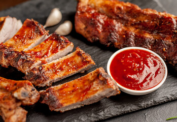  grilled pork ribs with spices on a stone background