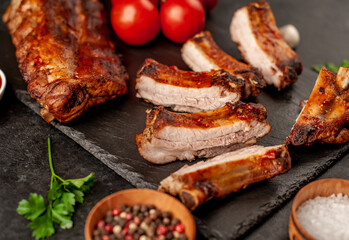 grilled pork ribs with spices on a stone background