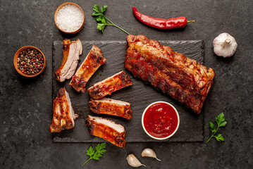 grilled pork ribs with spices on a stone background