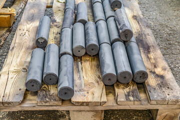 Hardened round blanks for parts after heat treatment lie on a wo