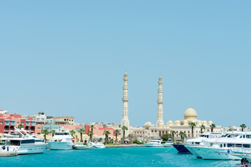 Sea bay with parked speed boats near Hurghada Mosque.