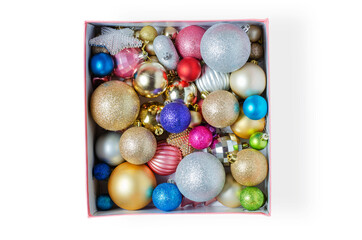 Christmas balls in a cardboard box for holiday decoration. Preparing for Christmas and New year. Isolated on a white background.