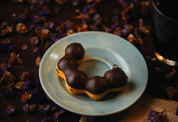 The chocolate donut serving on a blue plate