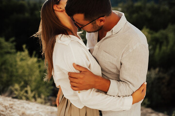 Close-up of couple in love, man kissing passionately on the neck his girlfriend.