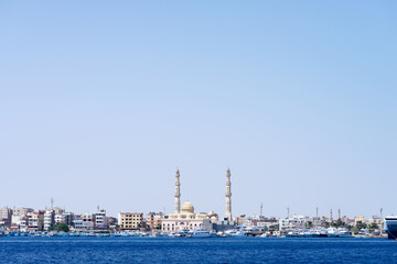 Sea bay with parked speed boats near Hurghada Mosque.