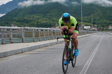Fototapeta na wymiar triathlon athlete riding a bike on morning training