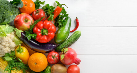 Mixed vegetables and fruits on the white wooden table, directly above, copy space.