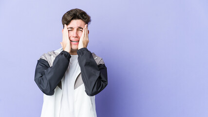 Young caucasian man isolated on purple background whining and crying disconsolately.
