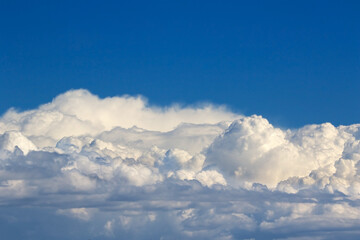 Beautiful dark blue sky background with white clouds.
