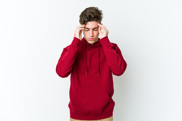 Young caucasian man isolated on white background touching temples and having headache.