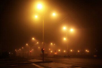 Illuminated empty highway in a fog at night
