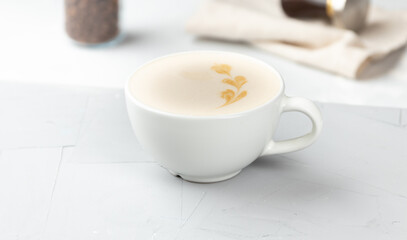 White cup of hot mochacino coffee on concrete background