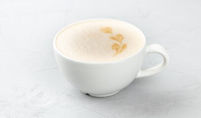 White cup of hot mochacino coffee on concrete background