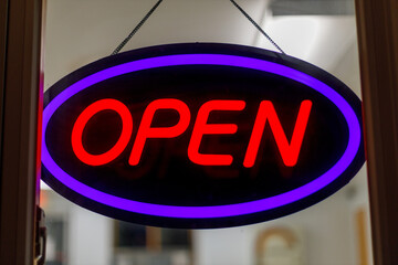 Close up of a neon open sign in window at night
