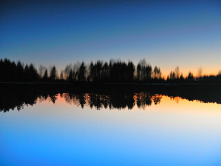 sunset on the lake with reflection 