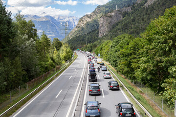 Rothenbrunnen, Switzerland: 12 August 2018 - Weekend traffic jam on the highway towards Swiss Alps creation regions, there is no contraflow in direction to metroplises. - obrazy, fototapety, plakaty