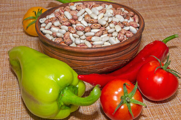 Beans, tomatoes and peppers on the background