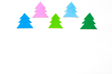 Fototapeta premium Colored silhouettes of Christmas trees on a white background, copy space