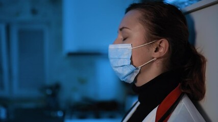 Exhausted young doctor or nurse during home visit feeling down