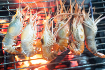 Grilled shrimps on barbecue flaming grill.