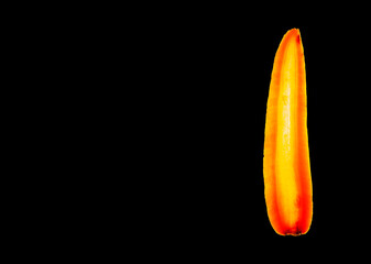 Detail of a slice of a carrot on black background
