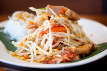 Thai spicy green papaya salad mix grilled pork neck served with rice vermicelli