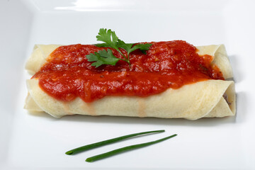 beef pancake with red sauce and parmesan cheese on a white plate