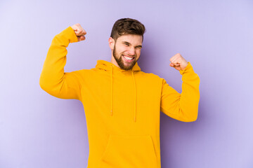 Fototapeta premium Young man isolated on purple background cheering carefree and excited. Victory concept.