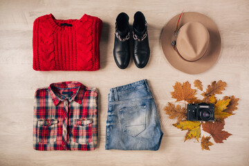 flat lay of woman style and accessories, red knitted sweater, checkered shirt, denim jeans, black leather boots, hat, autumn fashion trend, view from above, vintage photo camera, traveler outfit