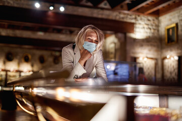 Woman exploring medieval expositions in museum