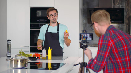 Handsome caucasian man chef filming cooking show or blog