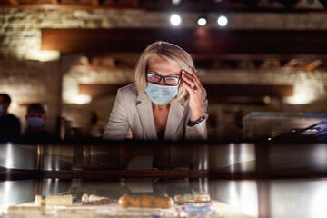 Woman in gallery room looking antiques