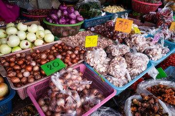 Onions and garlic in a basket at a fresh market