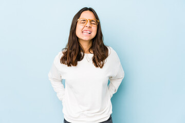 Young mixed race hispanic woman isolated funny and friendly sticking out tongue.