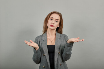 Young attractive woman, dressed gray jacket, with green eyes, light brown hair, background. Palms...