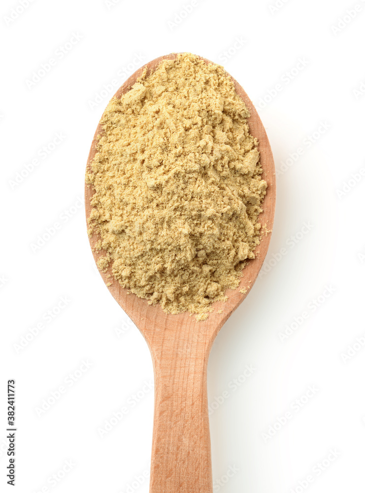 Sticker top view of mustard powder in wooden spoon