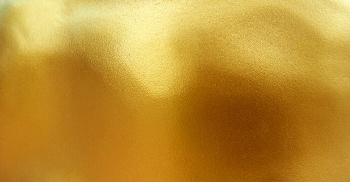 Gold wall paint abstract background with texture.
