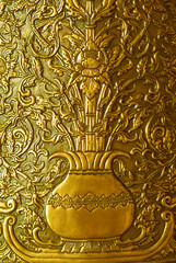 Fototapeta na wymiar Thai pattern gold flower emboss on wall.