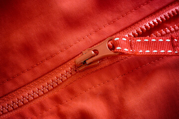 Closeup shot of a zipper on a red jacket