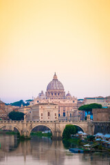 Fototapeta premium Sunset on Tiber river bridge with Vatican City - Rome, Italy