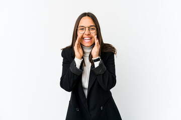 Young mixed race business woman isolated on white background saying a gossip, pointing to side reporting something.