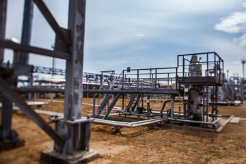 Oil refinery plant. Refinery pipelines and equipment. Tilt-shifted partially blurred photo. Uralsk region, Kazakhstan.